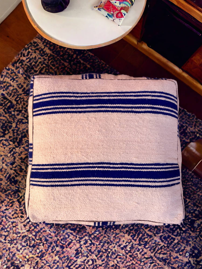 Authentic Moroccan charm in every thread. Unstuffed Berber rug pouf, crafted from 100% wool for warmth and comfort. A historic touch with a Moroccan pattern, ready for your personalization. Smooth zipper for easy customization. Embrace the authenticity delivered to your doorstep.