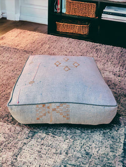 Introducing our Handmade Cactus Silk Pouf – a luxurious addition to your living space. Crafted from Sabra Silk, this square pouf brings Moroccan charm to your home. Elevate your living room with the unique design of a silk Ottoman Footstool. Immerse yourself in the comfort and style of this carefully Handmade Ottoman Pouf.