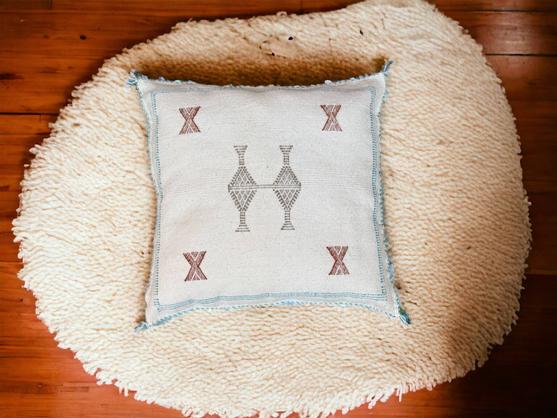 Handmade lumbar cushion with intricate Moroccan Sabra design, perfect for home decor.